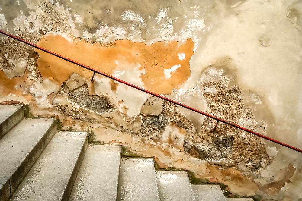 a set of stairs leading up to a dirty wall